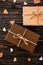 Two brown gift boxes on a wooden background with a bow of a simple rope on wood backgraund