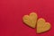 Two Brown Ginger Cookies in Heart Shape on Dark Red Background Corner Position. Valentine Romantic Love Greeting Card