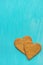 Two Brown Ginger Cookies in Heart Shape on Light Blue Background Corner Position. Valentine Romantic