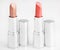 Two brown lipsticks isolated over white