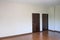 two brown room close door with white wall in new house. wooden laminate floor in living room. color paper tag for check defect in