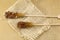 Two brown sugar sticks on rustic tablecloth