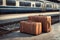 Two brown suitcases on the floor at the train station. Travel concept.