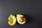 Two bruised imperfect avocado halves sitting on a black background with copy space