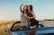 Two brunette woman standing near cabriolet