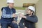 Two builders in hardhat taking coffee break