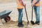 Two builders are leaning on shovels on the construction site