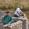 Two builders making walls