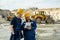 Two builders in workwear looking at sketch on tablet screen