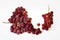 Two Bunches of fresh wine pink grapes falling isolated on a white background