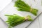 Two bundles of fresh barley grass on a white background