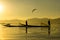 Two Burmese men paddle their legs Came out to find fish in the morning on Inle Lake