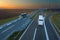 Two buses in motion blur on the highway at sunset