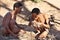 Two bushmen hunters kindle a fire