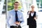 Two business colleagues in formalwear being outside