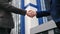 Two business man in suit greeting shaking hands outdoor downtown office district closeup