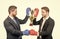 two business men in boxing gloves hold champion cup after corporate battle for leadership, victory.