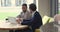 Two business partners men using laptop at co-working workplace table