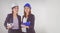 Two business women industrial engineers helmets with a tablet in