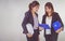 Two business women industrial engineers helmets with a tablet in