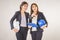 Two business women industrial engineers helmets with a tablet in