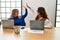 Two business worker woman raised up hands hitting five at the office