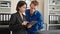 Two business workers using touchpad smiling at the office