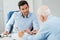 Two businessmen in discussion across office desk