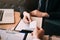 Two businessmen exchanged white business cards on a wooden table in office