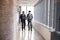 Two Businessmen Having Informal Meeting In Office Corridor