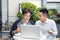 Two businessmen laughing while having a meeting in a classic cof