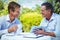 Two businessmen meeting in a restaurant using tablet