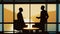 Two businessmen silhouettes negotiation in office across from panoramic window