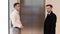 Two businessmen standing near elevator. Business people near a elevator in the office