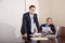 Two businessmen in suits working in boardroom