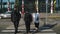 Two businessmen and woman walk across a road