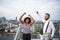 Two businesspeople standing against London view panorama, expressing excitement.