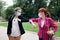 Two businesswoman with a medical mask on their face during the greeting elbows