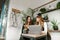 Two businesswomen colleague sitting in bright stylish laptop cafe discussing work with serious faces.Meeting of two office workers