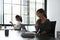 Two businesswomen employees colleagues working with together in office and using computer tablet.