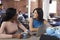 Two Businesswomen Have Informal Meeting In Office Coffee Bar