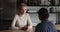 Two businesswomen negotiating and handshaking at office meeting