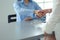 Two businesswomen sitting at a desk shaking hands