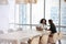 Two Businesswomen Using Laptop In Boardroom Meeting