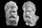 Two bust of Hercules. Heracles head sculpture, plaster copy of a statue isolated on black. Son of Zeus. Ancient statue