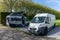 Two camper vans parked behind a hedge in an idyllic RV park in Holland