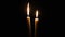 Two Candles Burn on a Black Background