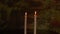 Two candles rotate in a circle. The light of the fire of two candles. Concept for meditation or xmas holiday. Garden