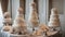 two candles on the table Wedding cakes tiered at an indoor party. The cakes have different shapes, sizes, and decorations.