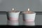 Two candles in white and pink concrete candle holders